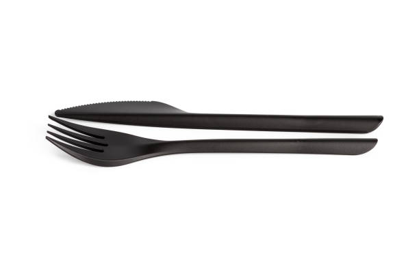 istock disposable black plastic fork and knife isolated on white background 1264729126