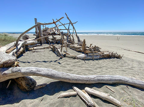 Driftwood house on the beach by Pacific ocean in northern California