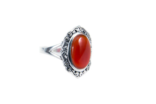 Silver carnelian ring isolated on white background. Orange cornelian silver carving isolated Silver carnelian ring isolated on white background. Orange cornelian silver carving isolated Carved Carnelian stock pictures, royalty-free photos & images