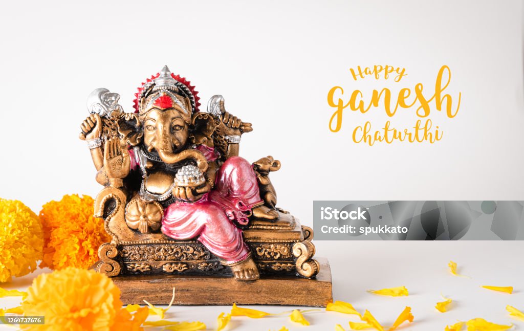 Happy Ganesh Chaturthi festival, Bronze Ganesha statue and Golden texture with flowers, Ganesh is hindu god of Success. Ganesh Chaturthi Stock Photo
