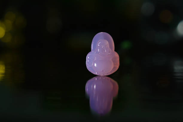 accessories A carved Buddha image Made from beautiful jade, resting on the ground with reflection