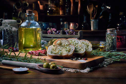 Slices of bread with olive oil and garlic appetizers in a rustic kitchen
