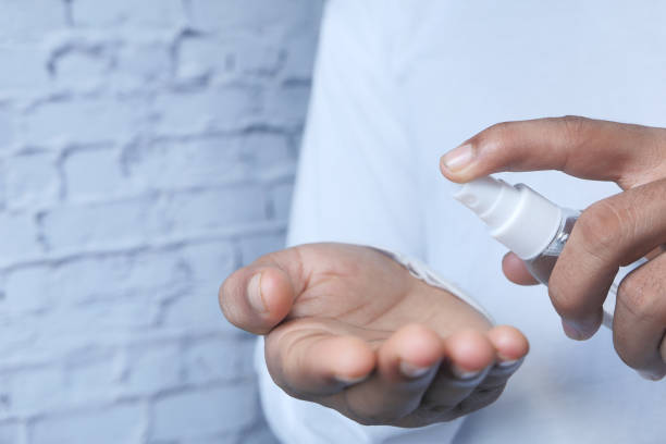 istock close up of young man hand using hand sanitizer spray. 1264761902