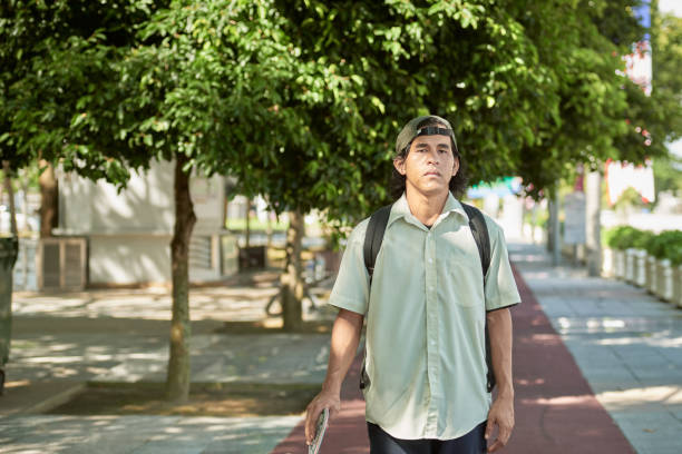 istock Asian male skateboarder walk to office 1264763234