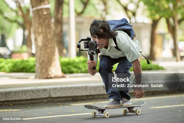 Asian Skateboarder Filming Using Video Recorder With Gimbal Stock Photo - Download Image Now
