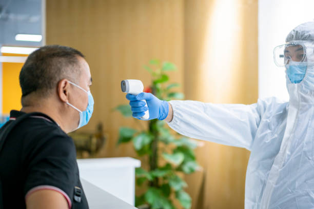 istock A man is tested for body temperature. 1264768373
