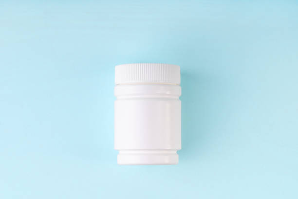 istock Bottle mockup on blue background. Blank package, bottle, container from pills, capsules. 1264770305