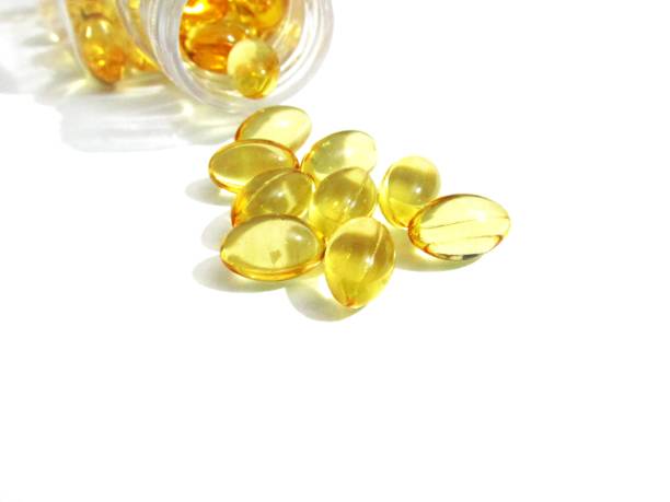 Cod liver oil  or fish oil gel capsules  on white background. Cod liver oil  or fish oil gel capsules  on white background. It contains omega 3 fatty acids , EPA,  DHA Soft Gel stock pictures, royalty-free photos & images