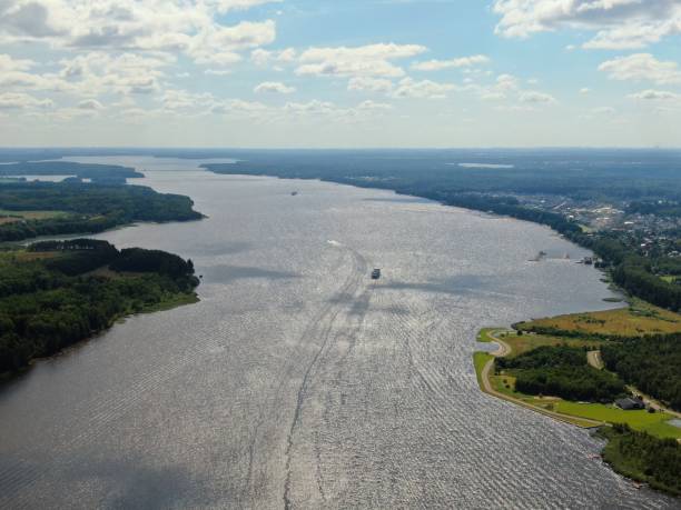 istock Aerial view journey by passenger ship along the river. Beautiful panoramic landscape from a height ship sails along a large river against the background of water and clouds 1264774744