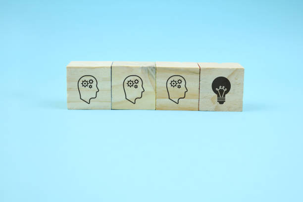 istock cubes with head symbols and hand that flips one revealing an idea 1264776321