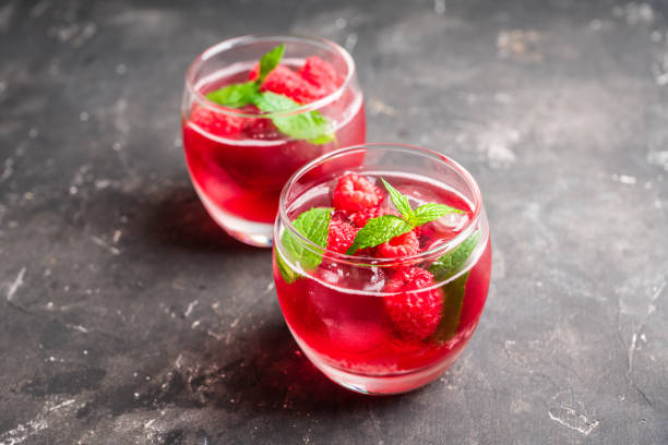 istock Raspberry and mint cocktail in glass on the rustic background 1264780672