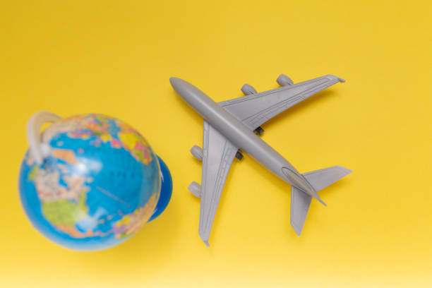 istock Small plane with globe. travel destinations 1264783515