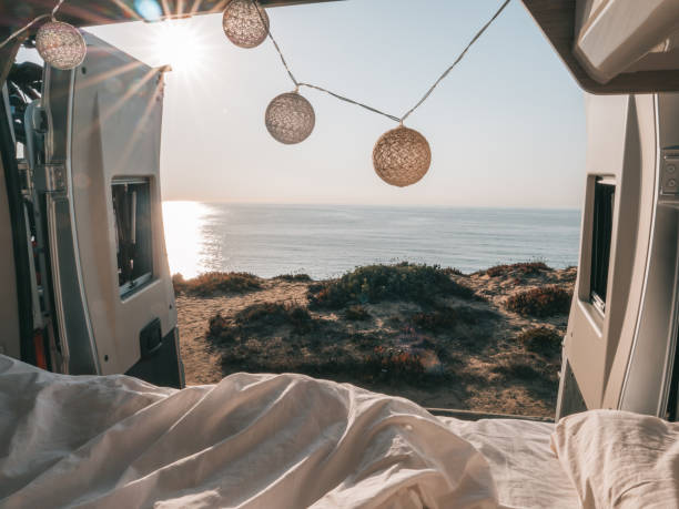 istock Back of a van overlooking the ocean, van life, bed view 1264785477