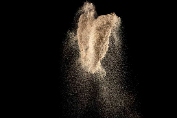 istock Brown colored sand splash.Dry river sand explosion isolated on black background. 1264785488