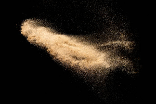 istock Brown colored sand splash.Dry river sand explosion isolated on black background. 1264785492