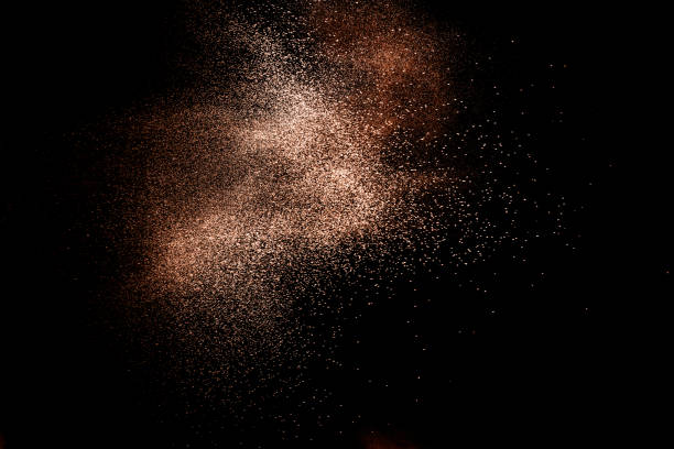 istock Brown colored sand splash.Dry river sand explosion isolated on black background. 1264785583