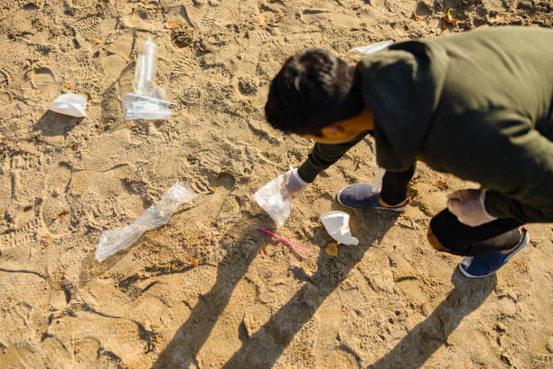 istock Top view of volunteer protecting environmental and picking up garbage at beach 1264788889