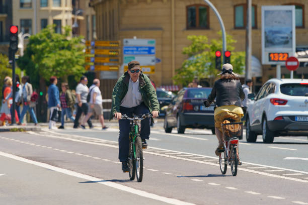 San Sebastian, Donostia / Spain - June 15, 2019: Lifestyle of fashionable spanish resort in sunny summer day. People biking. Basque Autonomous Community / country. High resolution image.