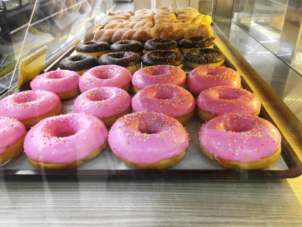istock Group of sweet donuts on plastic tray in bakery shop 1264798865