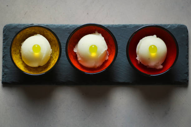 three cups of lemon sorbet decorated with pearls of juice
