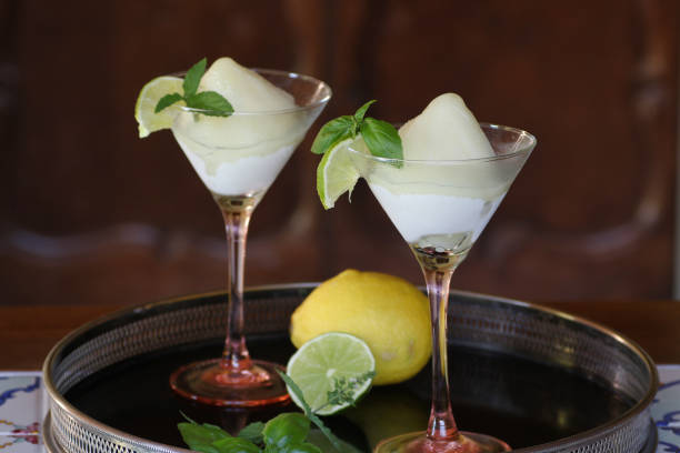 two cocktail glasses of lemon sorbet flavored with basil and lime two cocktail glasses of lemon sorbet flavored with basil and lime on black tray lime basil plant stock pictures, royalty-free photos & images