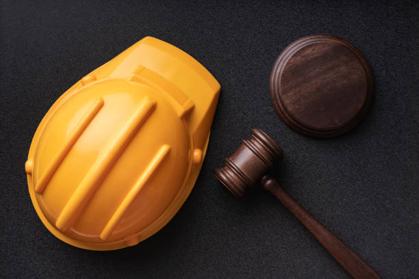 istock Construction helmet and judges gavel on black background. Top view. Construction law concept 1264804112