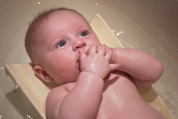istock Infant baby boy washed in small bath tub, view from above 1264805482