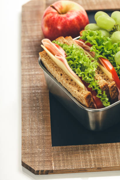 istock Lunch box with sandwich and fruits on chalk board 1264806466