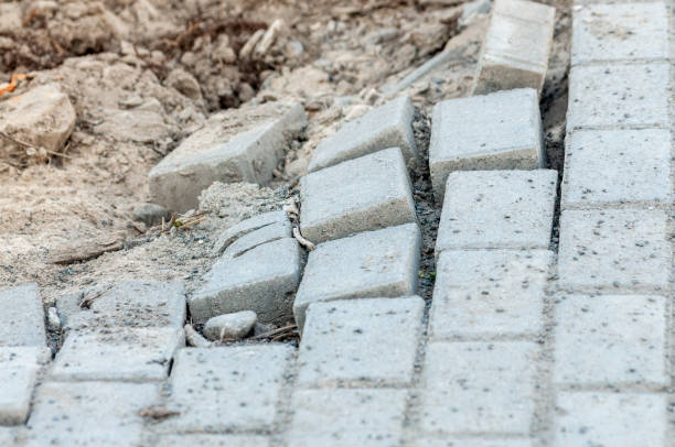 istock there is a big hole in the sidewalk. the sidewalk is paved with bricks. the pavement collapses. 1264810019