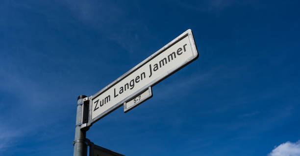 Zum Langen Jammer - to the long misery - street sign in Berlin, Germany "Zum Langen Jammer" (german: "To the long misery") unusual street name street sign against a blue sky in the Friedrichshain district of Berlin, Germany. friedrichshain photos stock pictures, royalty-free photos & images