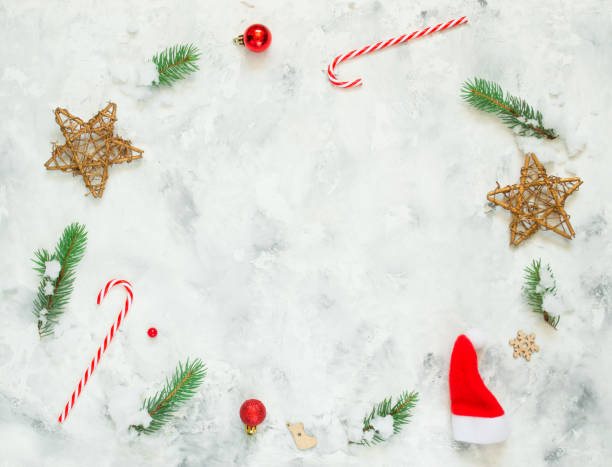 istock Christmas composition. Fir tree branches, snow, red Christmas balls on white concrete background. Christmas, winter, new year concept. Flat lay, top view, copy space. 1264810408