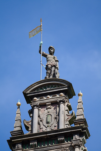 A vertical shot of a clock tower with statues in Aliados avenue, Porto, Portugal