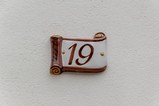 House number 19 on ceramic on a white house wall