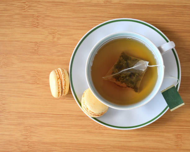 istock Cup of green tea and macaron top view 1264817486