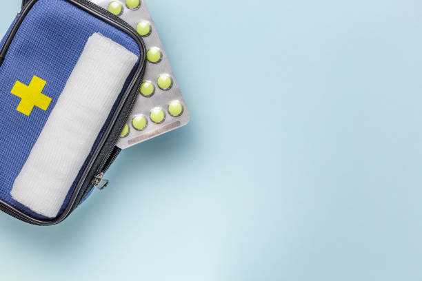 istock First aid kit for tourism, bandage, pain relieving pills for treatment and assistance in case of accidents in travel hiking on blue light medical background with copy space 1264817708
