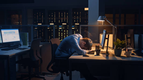 istock In the Office at Night, Overworked Tired Office Worker Fell Asleep at the Computer. Tired Frustrated Exhausted Businessman Fell asleep at His Job 1264819554
