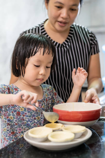 istock Asian girl cooking with mom 1264821332