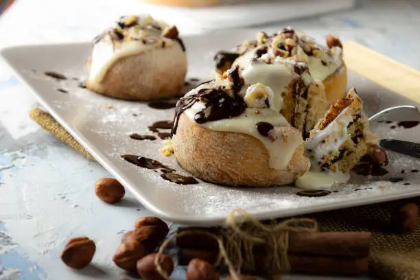 original cinnabon rolls with chocolate-cream sauce and hazelnuts