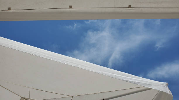 istock Textile textures of white beach umbrellas with high sky on backdrop 1264822949