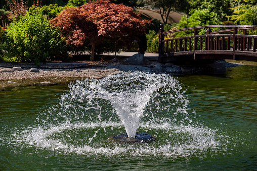 Conical water splash in pond at public park in Turkey.