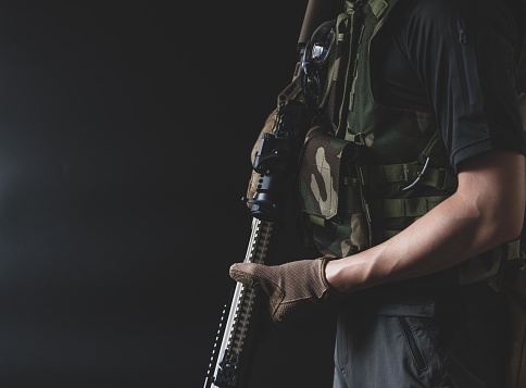 The man wearing bulletproof vest and holding weapon.