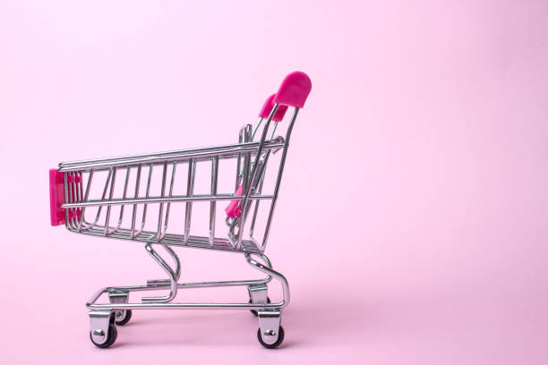 istock Metallic Small Shopping Cart on Pink background. Black Friday concept. Copy space for text. 1264826678