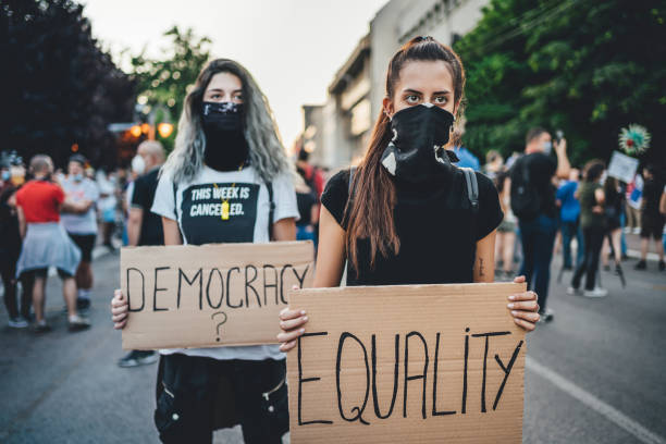 istock Young women protesters holding placards 1264826722