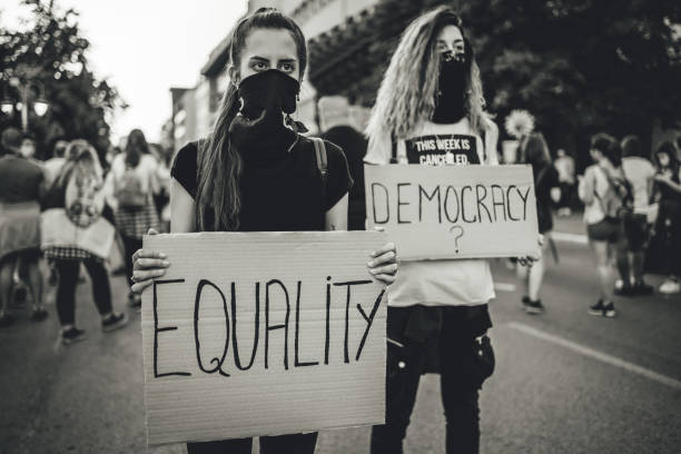 istock Young women protesters holding placards 1264827496