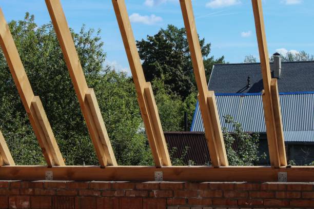 istock Roof trusses not covered with ceramic tile on a detached house construction, visible roof elements, battens, counter battens, rafters. Industrial roof system with wooden timber, beams and shingles 1264829848