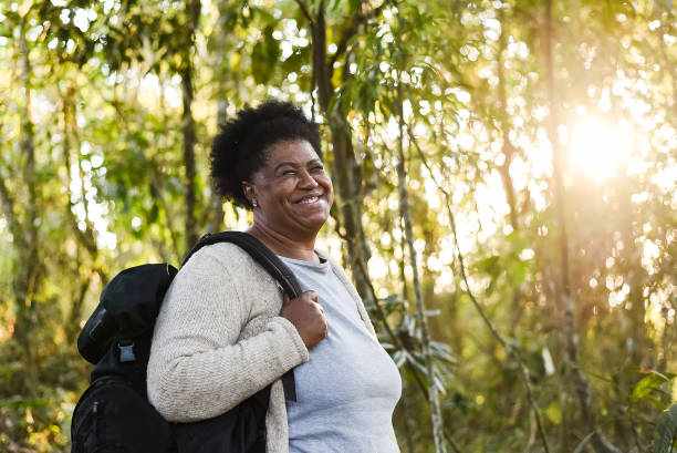 istock Backpacker senior woman in nature park 1264830313