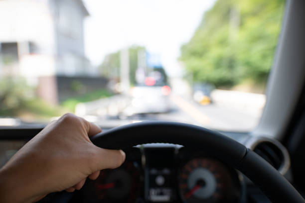 istock Hand holding a steering wheel to drive a car 1264831163