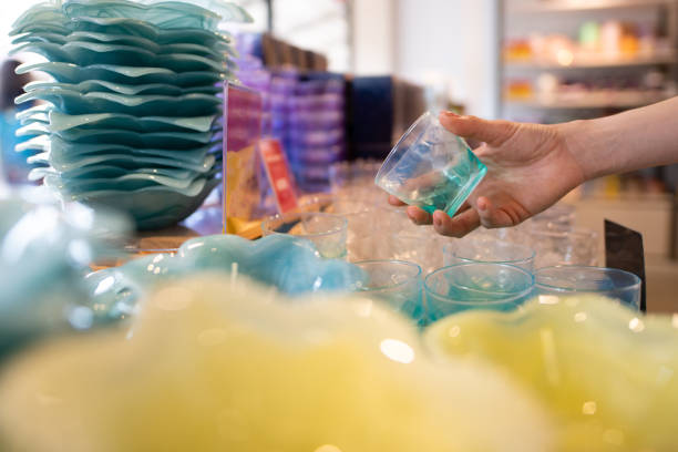 Female hand choosing a cup in a shop