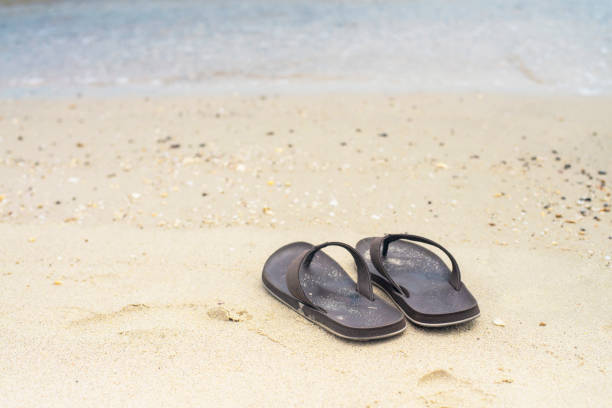 istock Flip Flops on a sandy ocean beach , Summer vacation concept. 1264837841