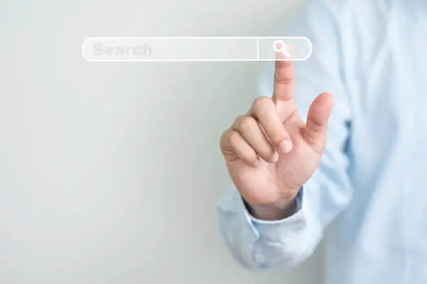Photo of Searching information network concept with copy space ,  Businessman using hand input keyword and click to virtual internet search page computer touch screen.